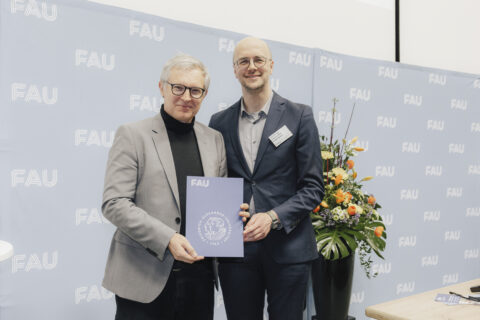 Two men holding an award